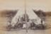 Men seated outside the tent of the Wharfdale Relics bicycle