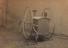 A bicycle with a front basket, photographed in a studio