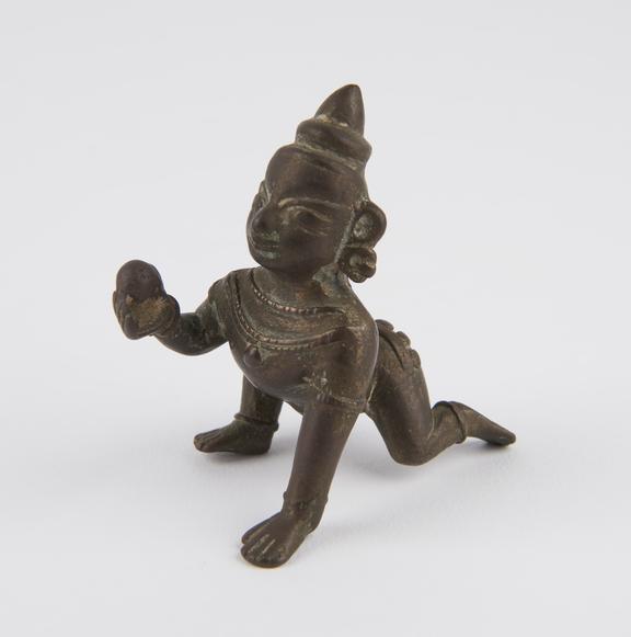 Brass figure of the Hindu god Krishna as the butter thief