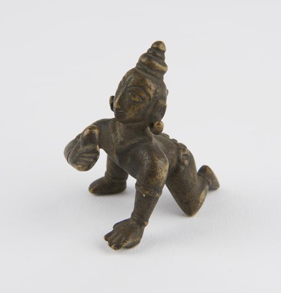 Brass figure of the hindu god Krishna as the butter thief