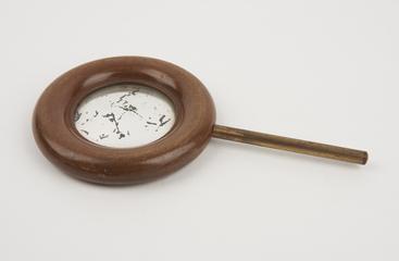 Concave mirror, in wooden ring on brass rod