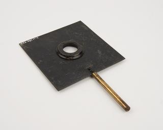 Iris diaphragm, fitted into square metal plate on metal rod