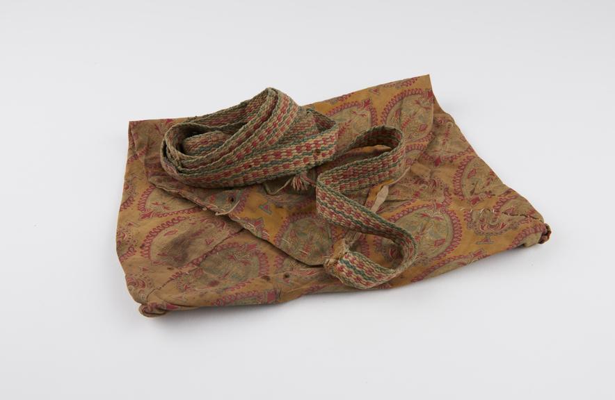 Yellow, stained, cotton bag with long wooven strap