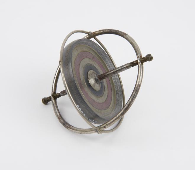 Toy gyroscope with string but no case.