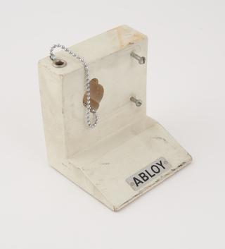 Wooden block with plaque reading 'Abloy'