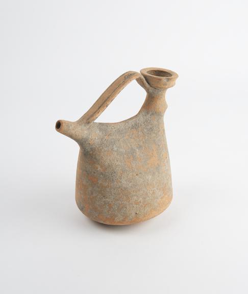 Terracotta feeding bottle with offset inlet and spout and arching handle