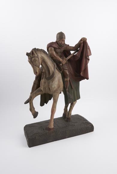 Wooden figure of Saint Martin of Tours astride a horse parting