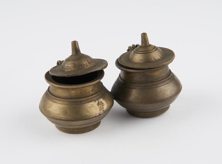 2 squat bulbous brass vessels with circular hinged lids