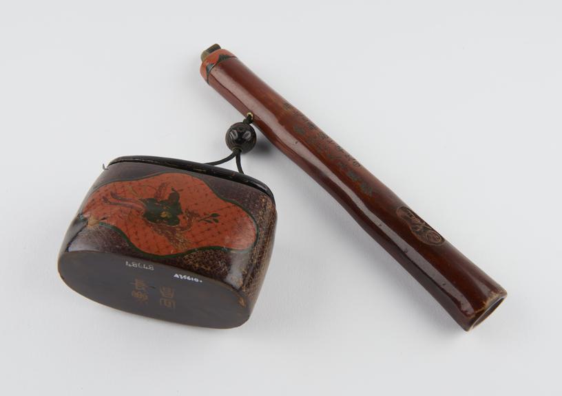 Tobacco pipe in case linked by cord via spherical ojime to