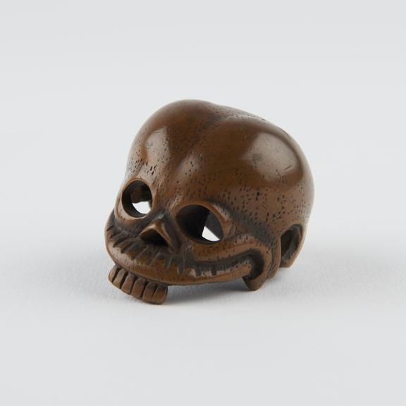 Wooden netsuke, in the form of a stylised human skull