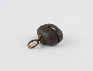 Egg-shaped case for small pistol, worn as netsuke