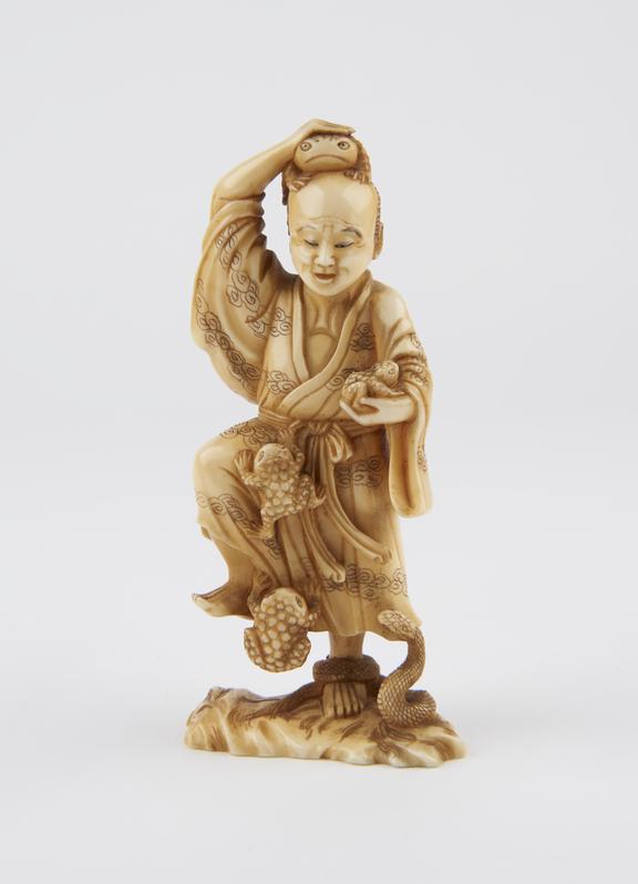 Ivory statue of a man with a snake coiled around his foot