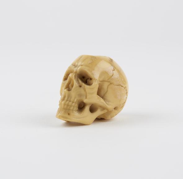 Ivory skull model, possibly a netsuke with holes for suspension