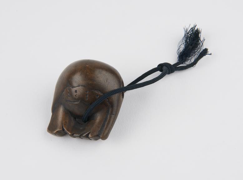 Wooden netsuke, carved in the form of a wood fish, or mokugyo