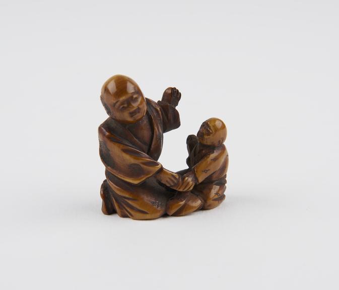 Ivory netsuke in the form of a man and child kneeling, Japanese