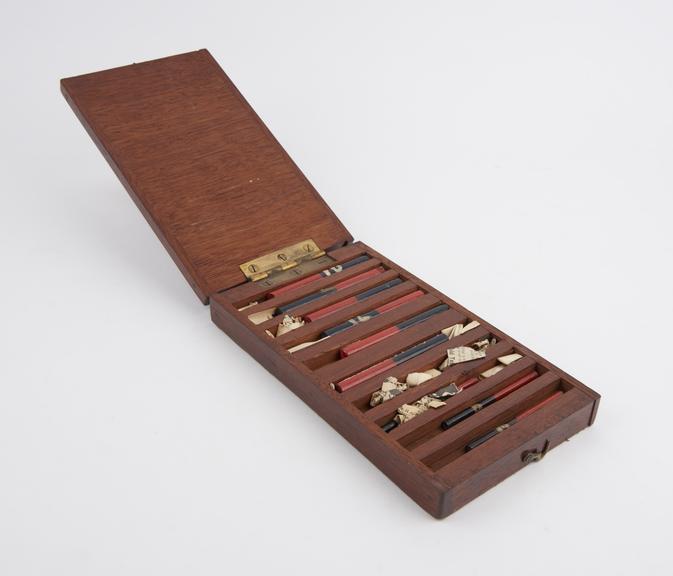 Wooden case containing six large cylindrical magnets and three