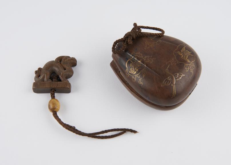 Carved wooden inro in the form of a pouch