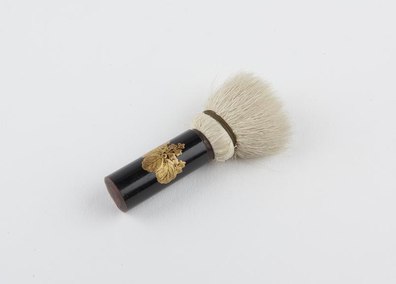 Hair face brush set into lacquered wooden handle