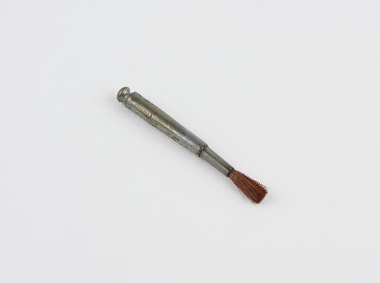 Small  hair brush set in metal handle, for painting the lips