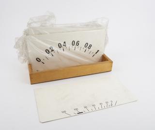 Eight different dials in storage tray, for demonstration meter