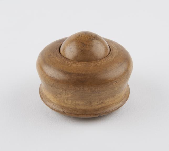 Turned wooden massage ball encased in turned wooden socket