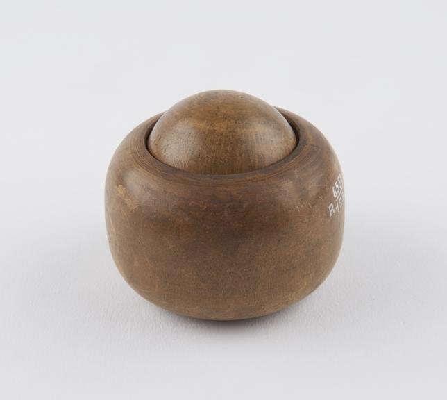 Small turned boxwood ball in wooden socket, which forms grip