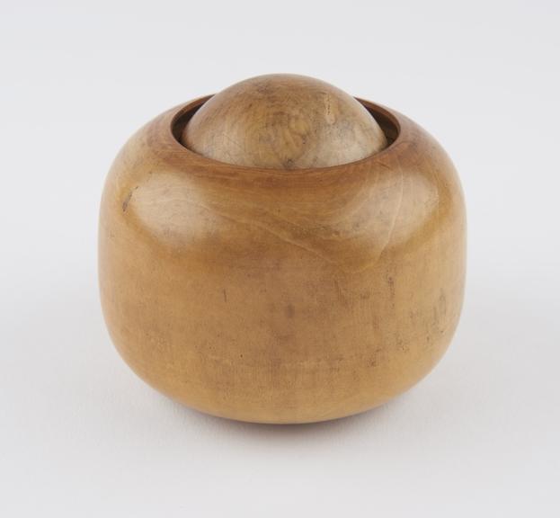 Turned boxwood massage ball, in turned wooden socket, Japanese