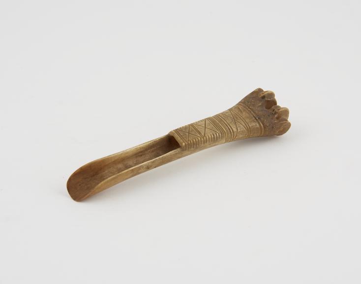 Apple scoop carved from sheep's tibia and decorated with carved geometric panels