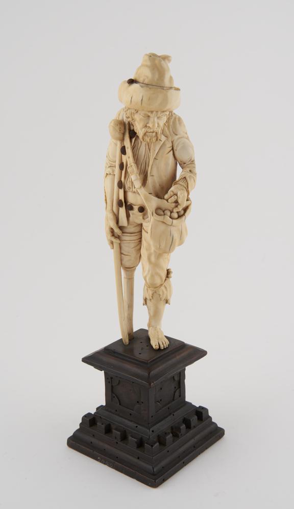 Ivory statue of a beggar, with crutch and wooden leg