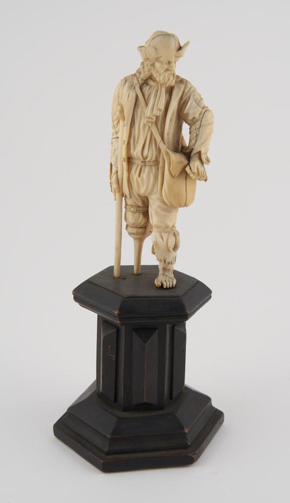 Ivory statue of a beggar, with crutch and wooden leg