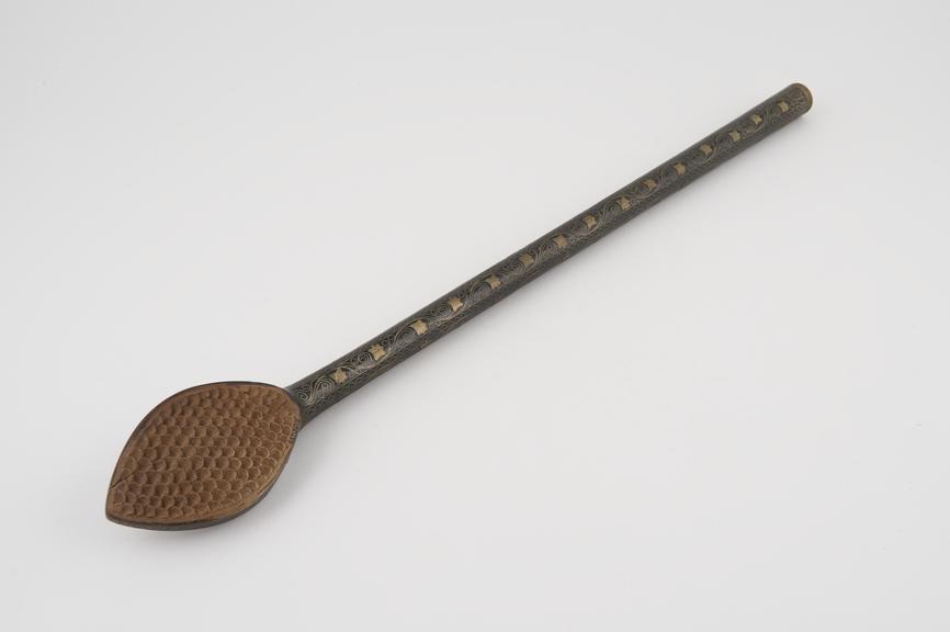 Black wooden back scratcher decorated with inlaid silver