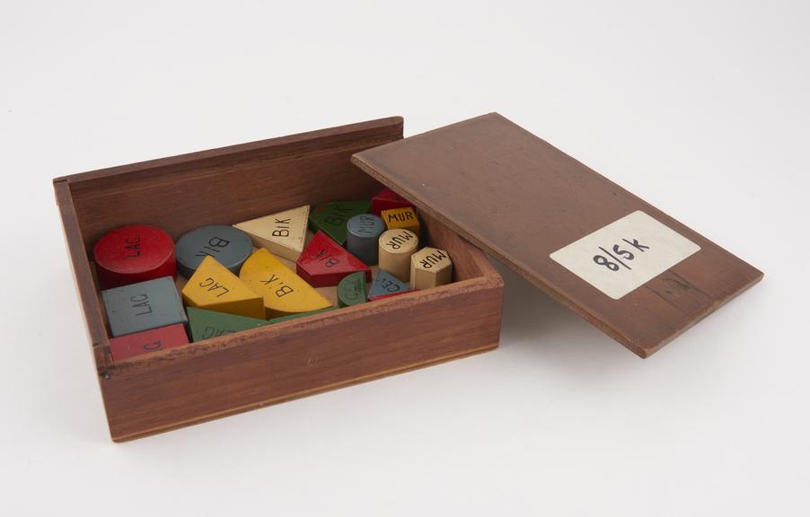 Box of 22 assorted wooden shapes in various colours