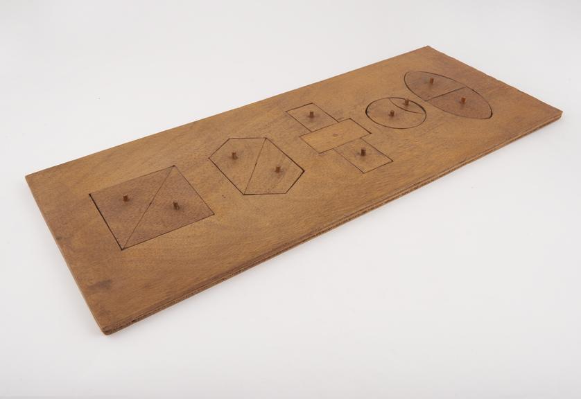 Formboard with five shapes, no maker marked