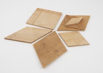 Five wooden shapes, one has three layers