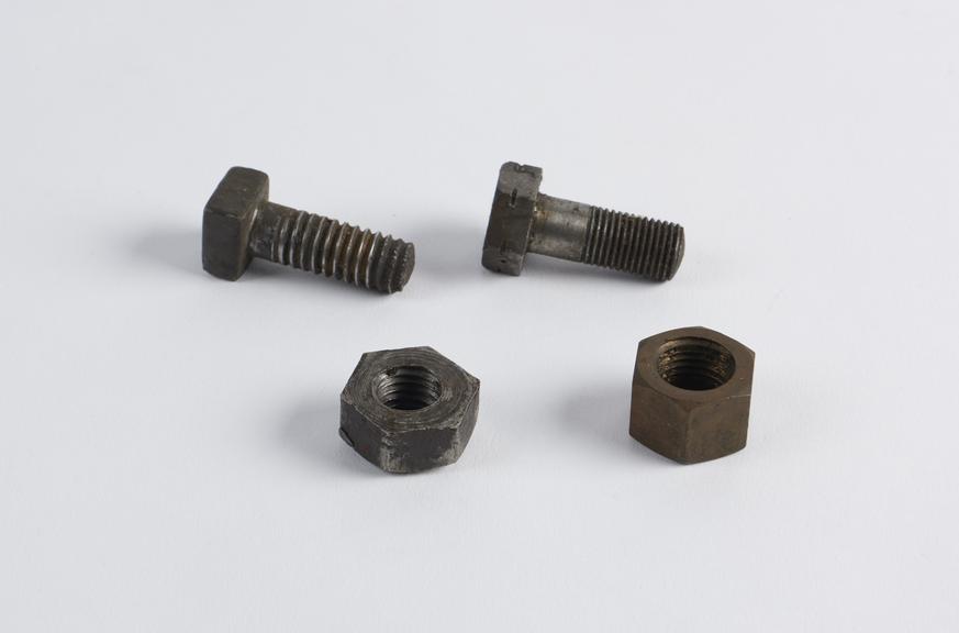 Two nuts and two bolts from the three wheeled motor car