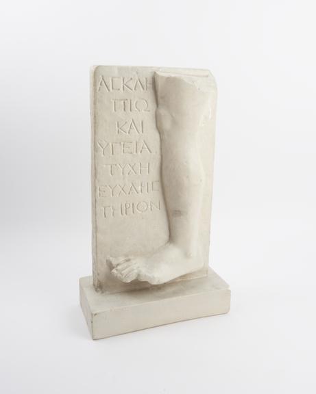 Votive left leg on inscribed plaque