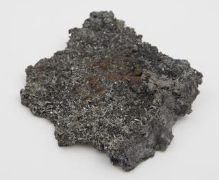 Crystals on the surface of tin-slag and in cavities