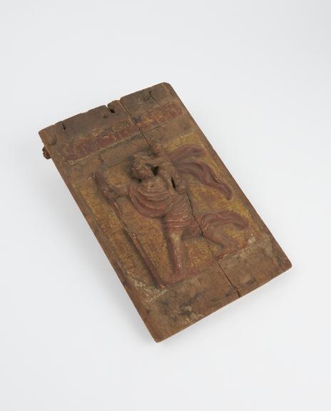 Small carved wooden painted panel presumably depicting St. Christopher carrying a child on his shoulder (relief)