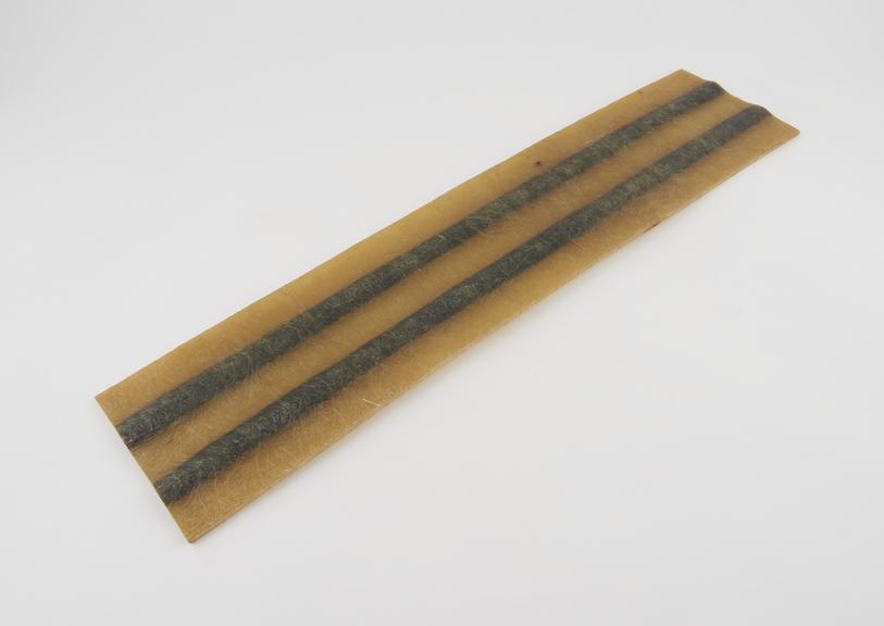 Sample of polyester glass fibre reinforced with carbon fibre.