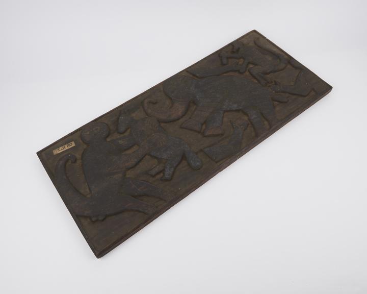 Rectangular wooden plaque carved with zoomorphic figures in