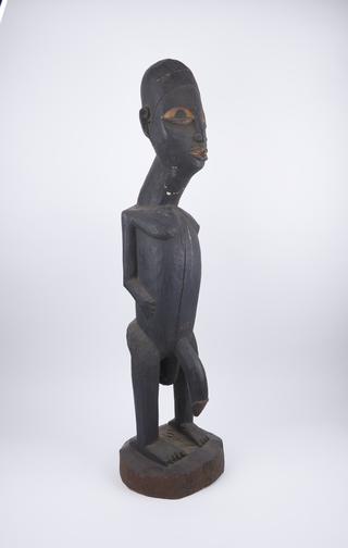 Male figure of carved wood on rand base