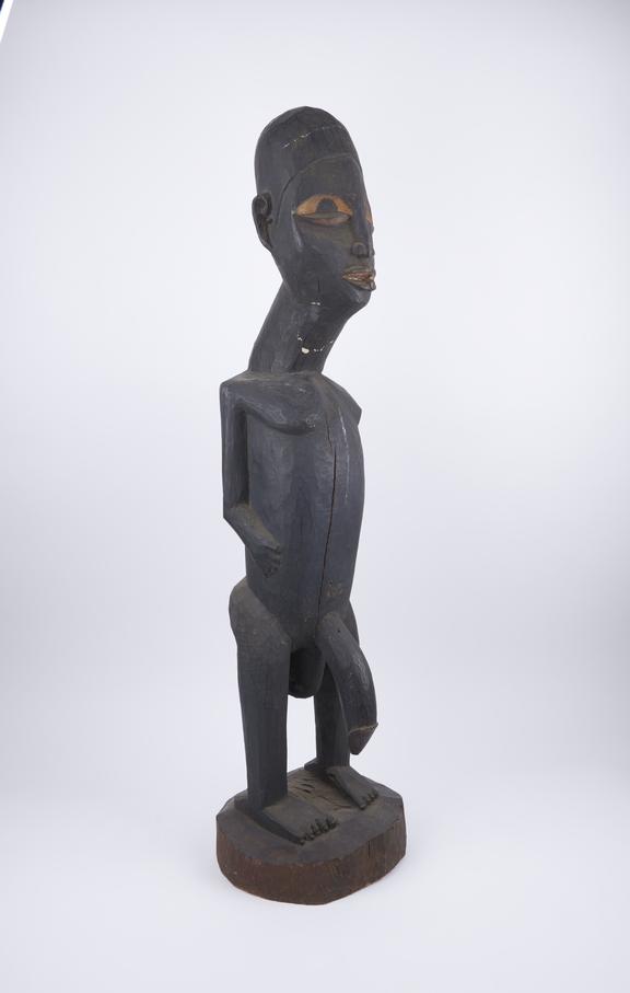 Male figure of carved wood on rand base