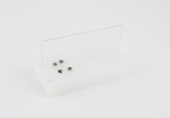 Two screws and a spare glass pane