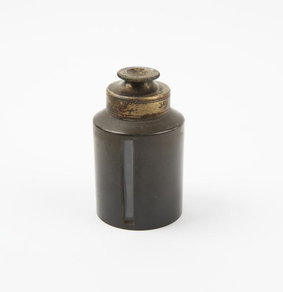 Glass chloroform bottle with metal cap and vulcanite jacket