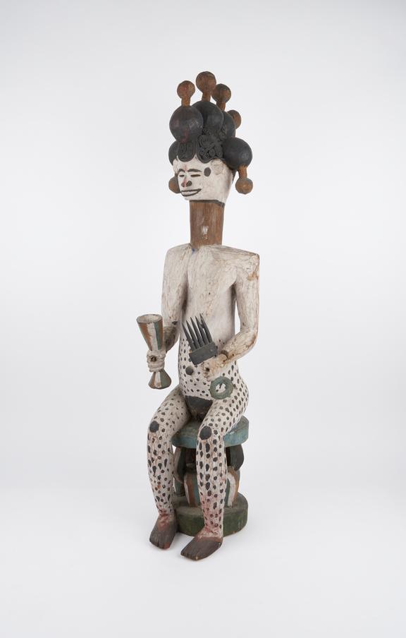 Carved wooden figure, female, seated, with elaborate hair