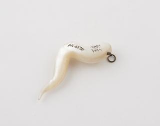 Mother of pearl amulet in the form of a twisted horn
