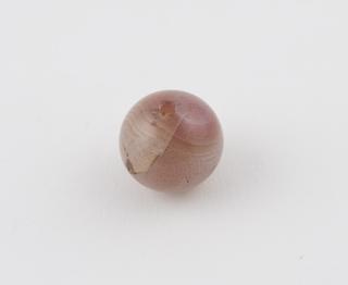 Translucent spherical bead of pinkish chalcedory