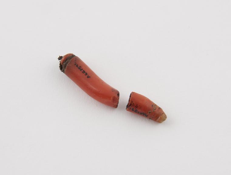 Coral amulet banana shaped, broken in two, originally mounted