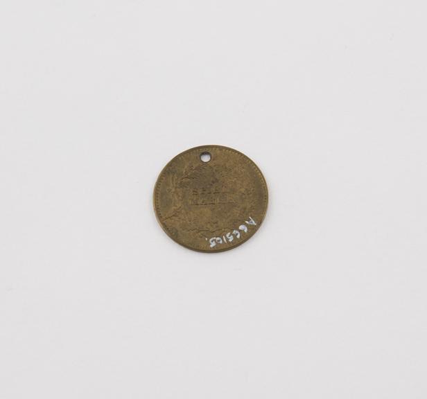 Perforated brass coin-token, amuletic