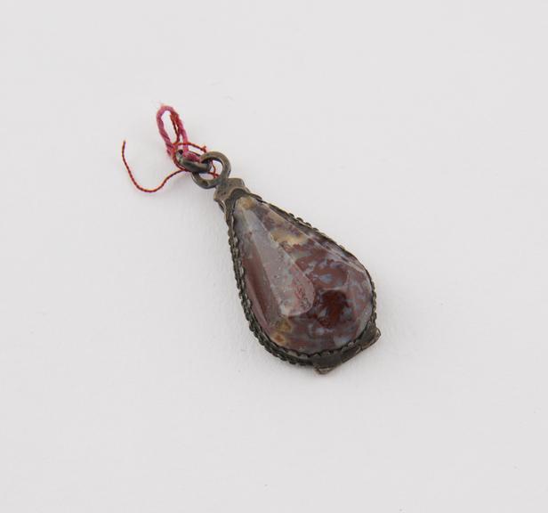 Amuletic pendant, locket type which opens at back